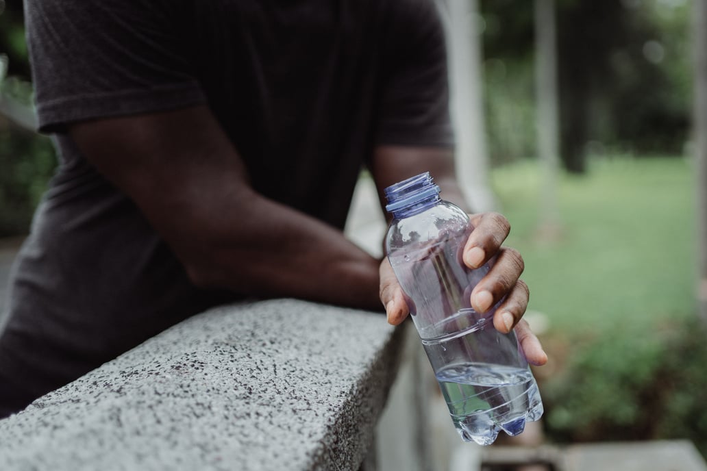 Photo of Person Holding Clear Plastic Bottle